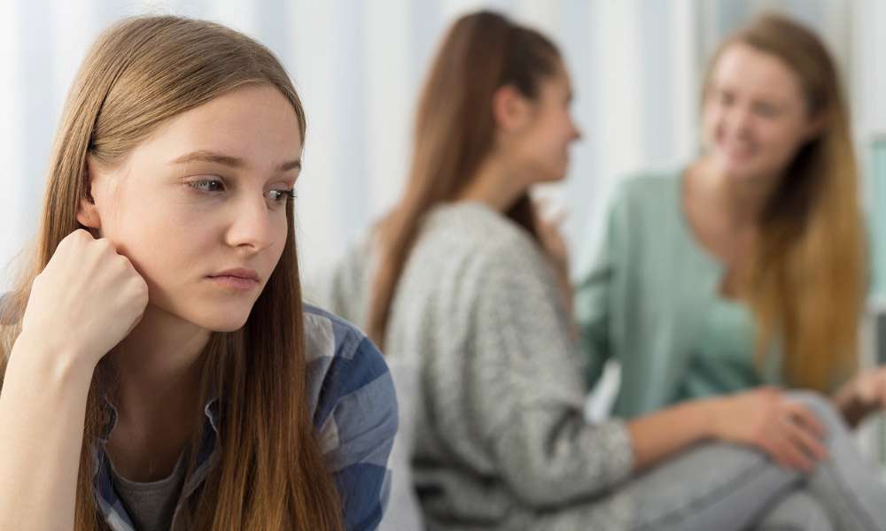 Individual experiencing early depression symptoms such as sadness, emotional exhaustion, and low motivation