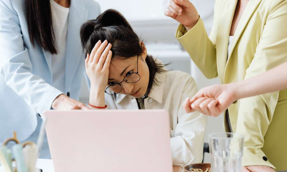 Person struggling with anxiety affecting workplace performance and relationships